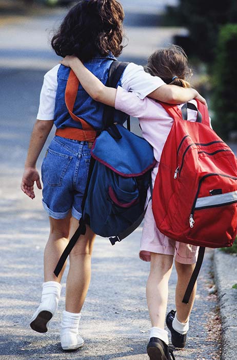 Friends with backpacks going to school