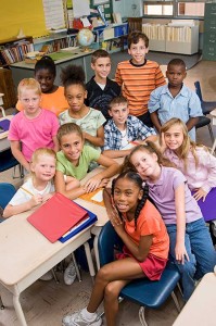 children in classroom looking up from desks