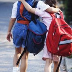 Friends with backpacks going to school